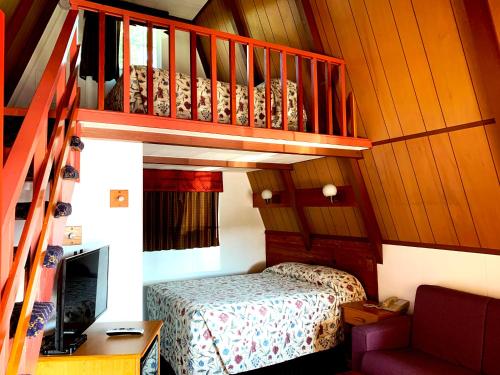 OaklandThe Ranch Motel的一间小卧室,配有一张床和一个楼梯