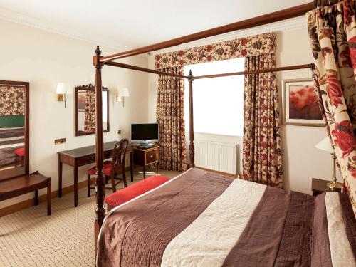约克约克费尔菲尔德庄园美居酒店的配有一张床和一张书桌的酒店客房