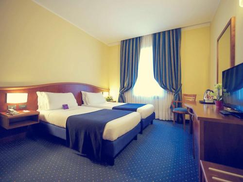 热那亚热那亚圣比亚焦美居酒店的酒店客房设有两张床和一台平面电视。