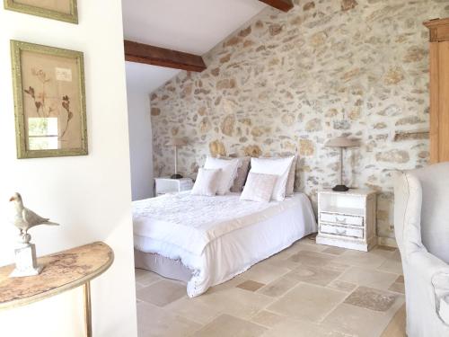 滨海圣西尔百思迪德方威尔 - 查布斯帝豪酒店的一间卧室设有一张床和石墙