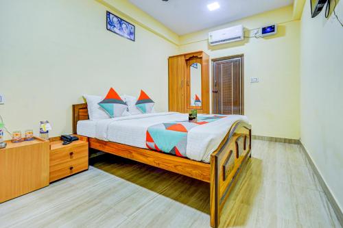 哥印拜陀FabExpress Ragu Residency的一间卧室配有一张大床和一个梳妆台