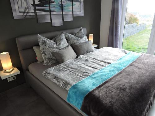 温特贝格Appartement - Haus Winterberg的卧室配有带枕头的床铺和窗户。