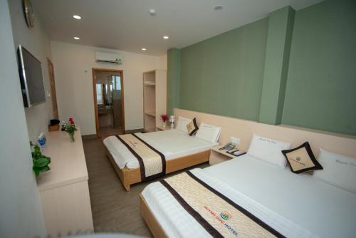Huynh Duc 2 Hotel客房内的一张或多张床位