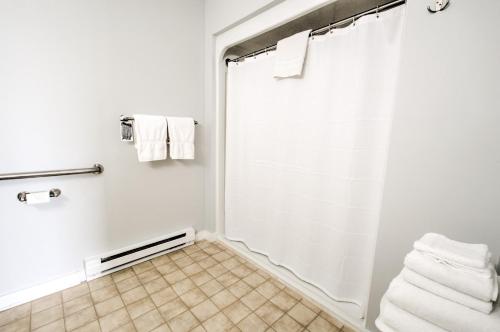 霍利East Shore Lodging的带淋浴和白色毛巾的浴室