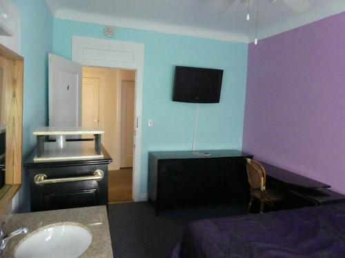 洛杉矶弗洛雷斯酒店的一间带水槽和紫色墙壁的浴室