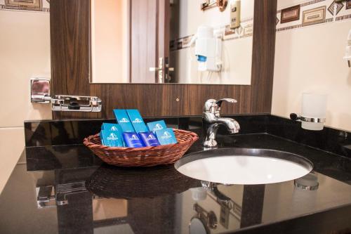 科恰班巴Hotel Pairumani的浴室水槽和洗浴用品篮