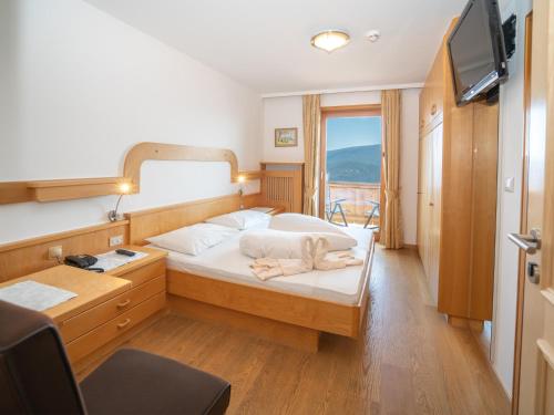 马兰扎奥博勒纳酒店的一间卧室配有一张带镜子的床和窗户