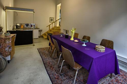 柏林弗里德里希 - 威廉膳食公寓的客房内的一张带椅子的紫色桌子