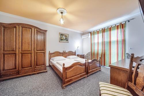马里博尔特拉纳佳妮酒店的一间卧室配有木床和木柜