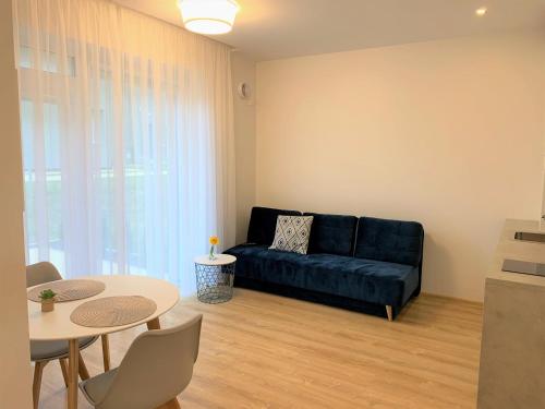 考纳斯COZY Nest apartment in Kaunas的客厅配有黑色沙发和桌子