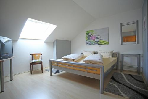 拉姆斯泰因-米森巴赫Ferienwohnung Ramstein的一间卧室配有一张床和一台电视。