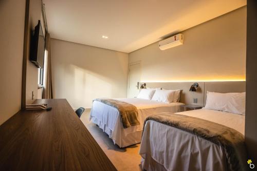 NAIM Hotel客房内的一张或多张床位