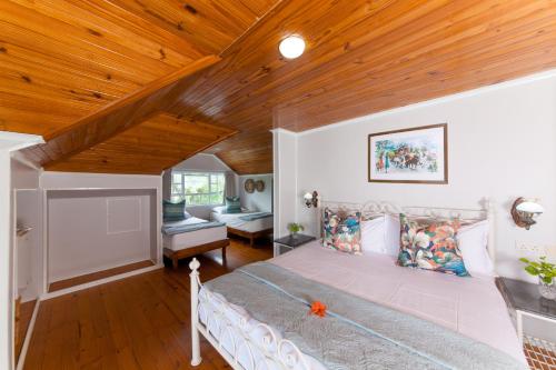 普拉兰大安塞区棕榈滩酒店的一间卧室设有一张床和木制天花板