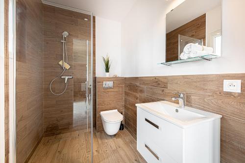 梅尔诺New Wave Resort Mielno的带淋浴、卫生间和盥洗盆的浴室