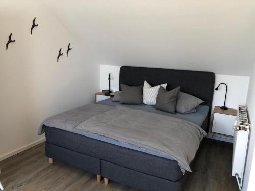 费马恩Quartier Meerblick的卧室配有一张大床,墙上有鸟