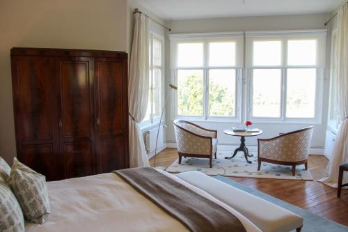 Trèves-CunaultManoir de Beauregard - Cunault的一间卧室配有一张床和一张桌子及椅子