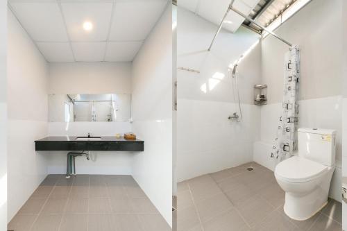 富国Colorful Home Stay Phú Quốc的白色的浴室设有卫生间和水槽。