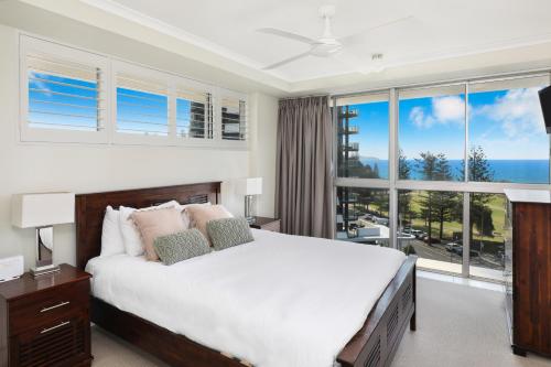 黄金海岸北角公寓酒店的一间卧室设有一张大床和一个大窗户