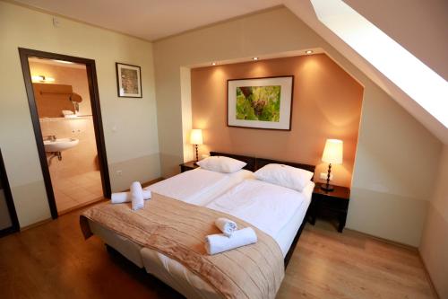 巴拉顿菲赖德Fürjes Villa Panzió的酒店客房带两张床和一间浴室