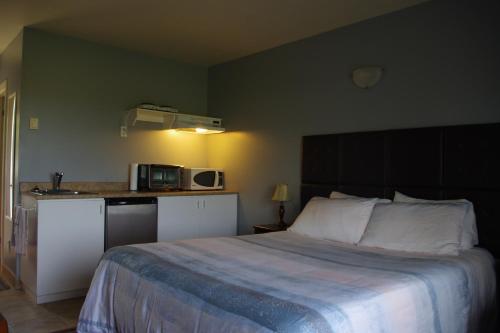 卡穆拉斯卡海军陆战队汽车旅馆的一间带大床的卧室和一间厨房