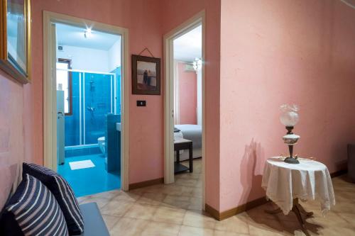 莱切Family Friendly House的一间设有粉红色墙壁和一张带台灯的桌子的房间