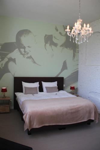 哈瑟尔特库切游玩住宿加早餐旅馆的一间卧室配有一张带吊灯的大床