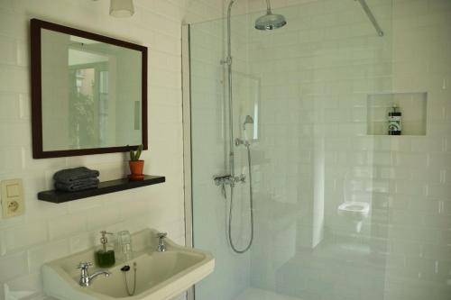 安特卫普Quiet apartment in Antwerp near parc - B&B InterMezzo - business & leisure的带淋浴和盥洗盆的白色浴室