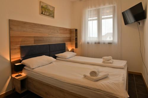 兹拉蒂博尔The View Zlatibor Hills的一间卧室配有一张床,上面有两条毛巾