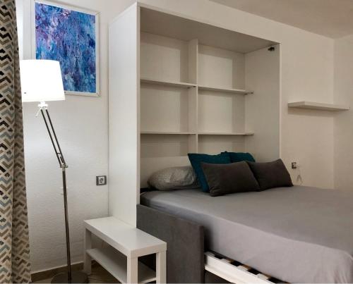 多列毛利诺斯Castillo Santa Clara的一间卧室配有床、台灯和架子