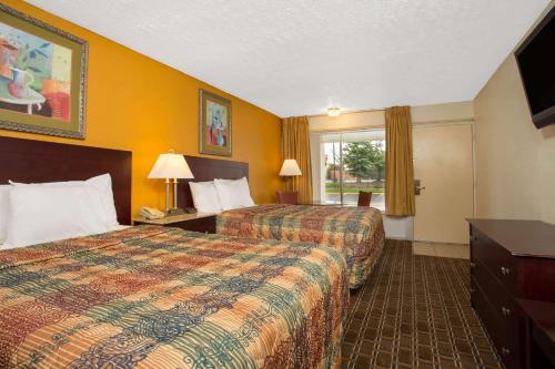 切斯特切斯特戴斯酒店的酒店客房设有两张床和窗户。