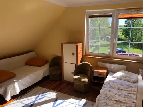 Stary FolwarkPrzystań Stary Folwark的小房间设有两张床和窗户