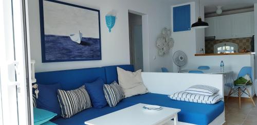 桑帕克Els Vents, tu apartamento junto al mar en Son Parc的客厅配有蓝色的沙发和桌子
