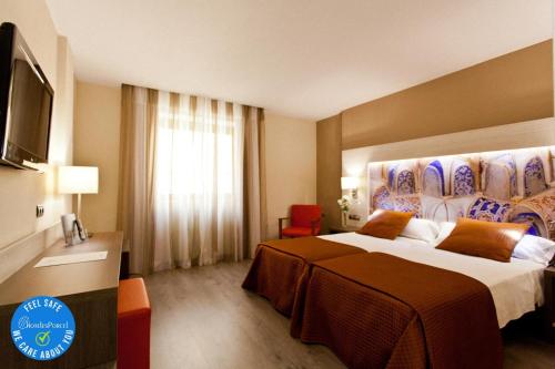 格拉纳达Porcel Sabica的酒店客房设有一张大床和一台电视。