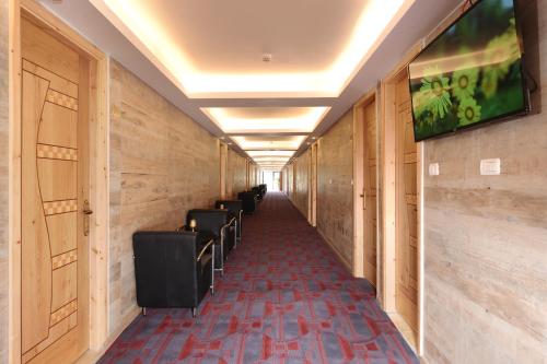 米茨佩·拉蒙Tzukim Desert Traveler's Hotel - מלון צוקים的大楼里带一排椅子的走廊