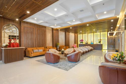 岘港Gold Plaza Hotel Da Nang的大楼内一个带沙发和椅子的大堂