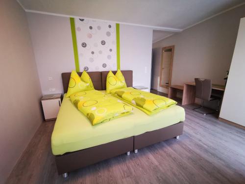 GobernitzPension Puster的一间卧室配有两张带黄色枕头的床