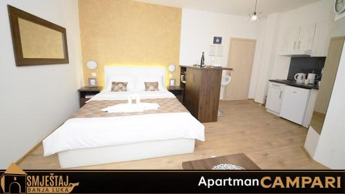 巴尼亚卢卡Apartman Campari的一间带大床的卧室和一间厨房
