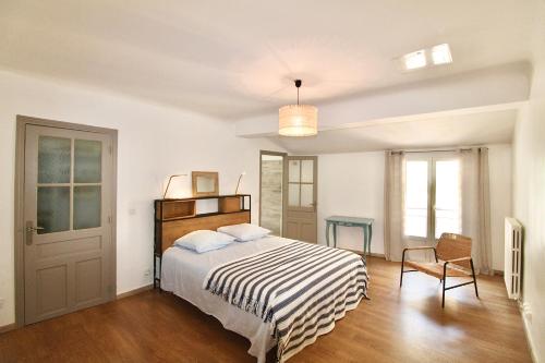 塞特港Grand appartement avec vue sur quai的白色卧室配有床和椅子