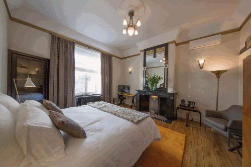 布鲁塞尔路易庭院住宿加早餐旅馆的卧室设有一张白色大床和一扇窗户。