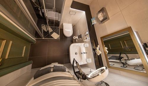 普劳恩普劳恩公园酒店的一间带水槽、卫生间和镜子的浴室