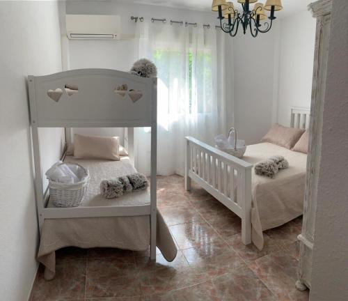 圭哈尔谢拉Casa Vista Nevada的一间卧室配有两张双层床和一张婴儿床。