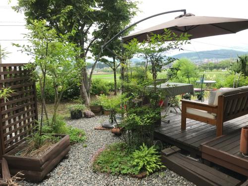 富山ヨーコのお宿 わくわく的木制甲板上配有长凳和遮阳伞