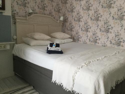 Zottegem精美鲜花住宿加早餐酒店的一张带白色棉被的床和袋子