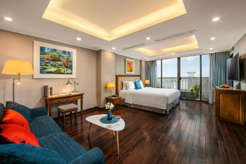 河内Hanoi Dalvostro Valentino Hotel & Spa的酒店客房,配有床和沙发