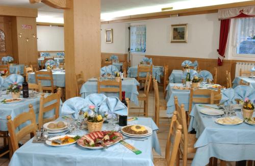 帕苏德尔托纳莱拉罗恰酒店的一间配备有蓝色桌椅的用餐室
