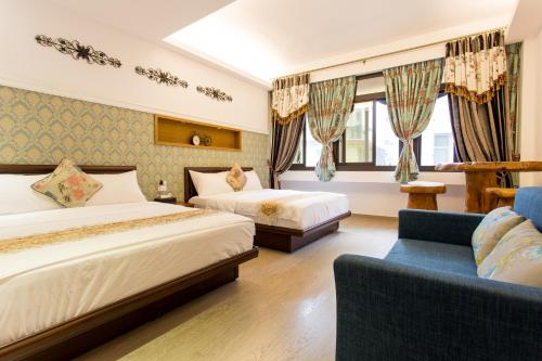 花莲市家乡民宿的酒店客房,设有两张床和一张沙发