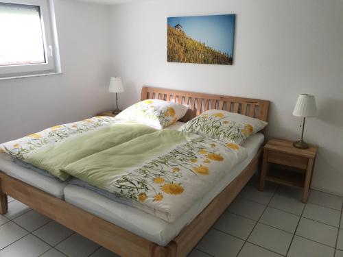 贝尔恩卡斯特尔-库斯Ferienhaus Moselglück - kostenlose ÖPNV-Nutzung inbegriffen的一张带毯子的床和两个枕头
