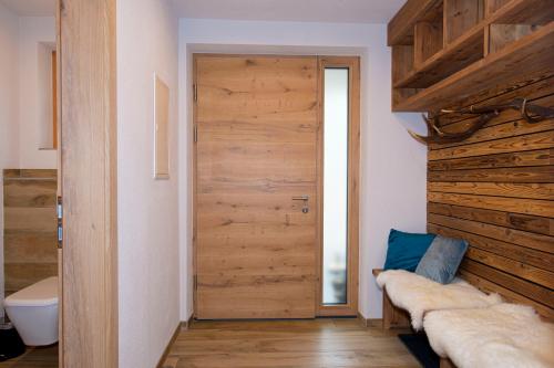 埃尔毛Appartement Enzian & Mark的客房设有木门和卫生间。