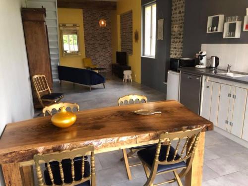 LarreuleDomaine Saint Esselin的厨房以及带木桌和椅子的用餐室。