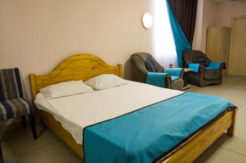 巴尔瑙尔Hotel Chaika的一间卧室配有一张床和两把椅子